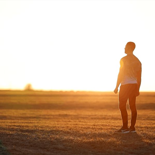 Silhouette of a person feeling energized against a morning sun background.